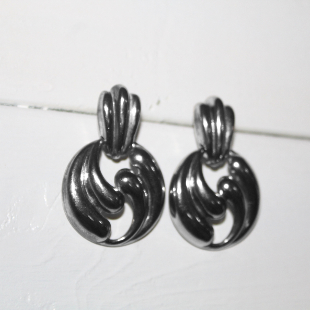Pair of silver earrings on a white background