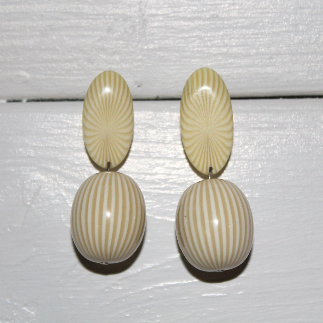 Pair of earrings with striped design on a white background