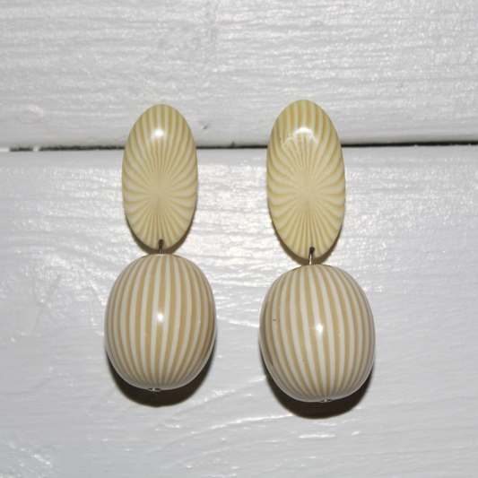 Pair of earrings with striped design on a white background