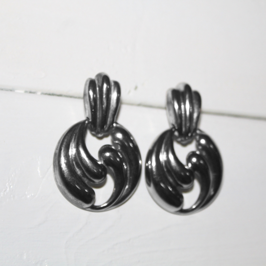 Pair of silver earrings on a white background