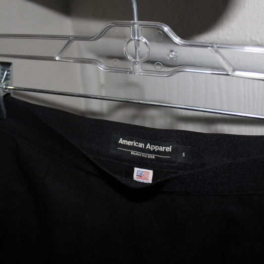 Black t-shirt with American Apparel label on a clear hanger.