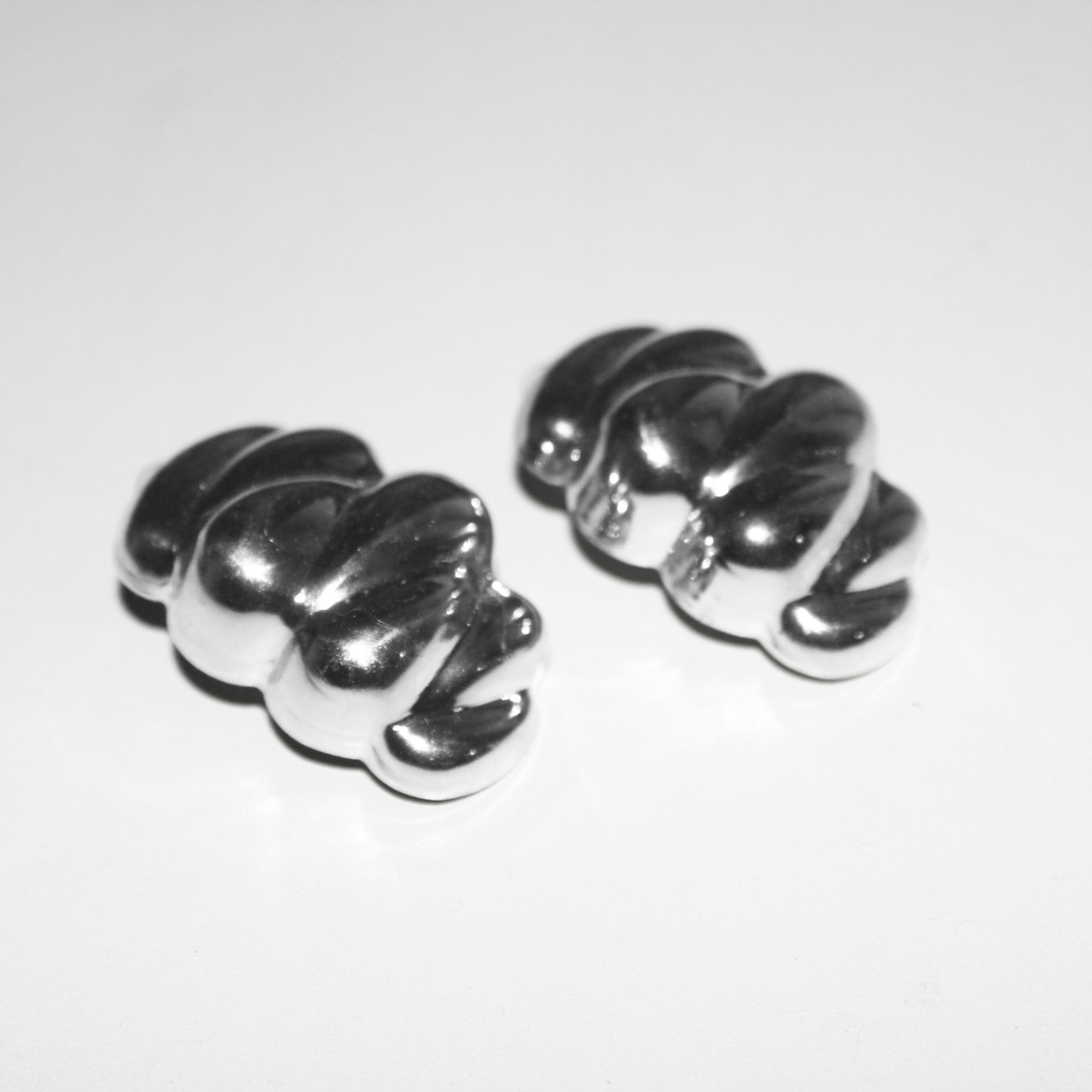 Pair of silver chunky silver earrings on a white background